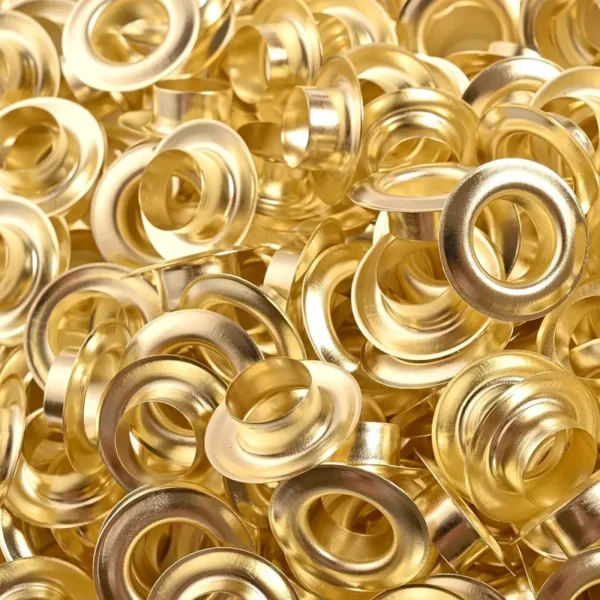 a pile of gold metal eyelets